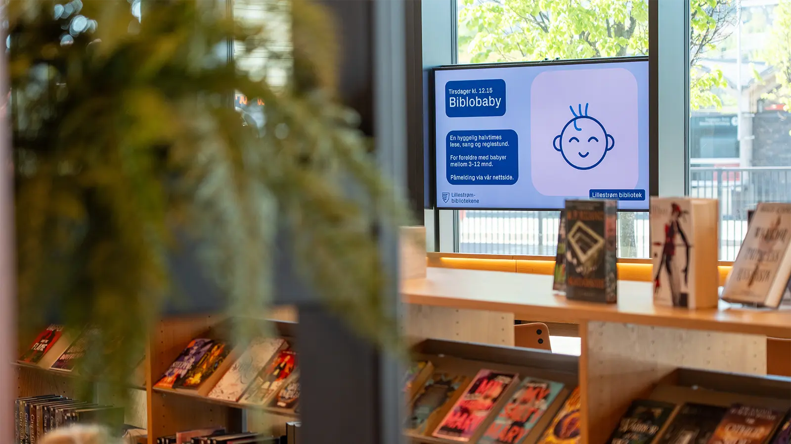 A digital information screen in the children's section promoting the Bibliobaby event.