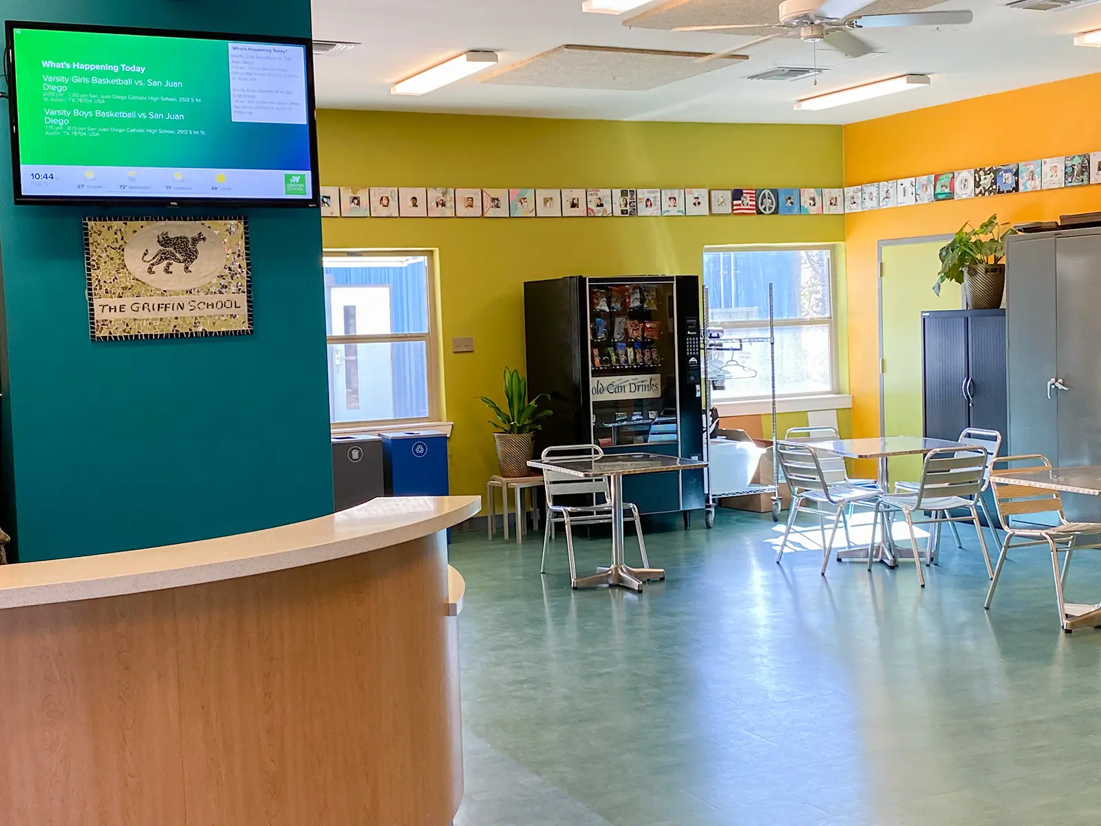 A digital display on the wall in a school reception.